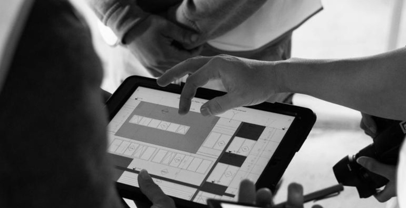 Raland team reviewing plans on a tablet